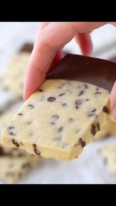 a hand holding a chocolate chip cookie bar