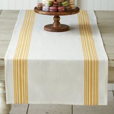 a table topped with a cake covered in macaroons on top of a plate