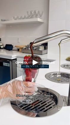 a person pouring liquid into a blender in a kitchen