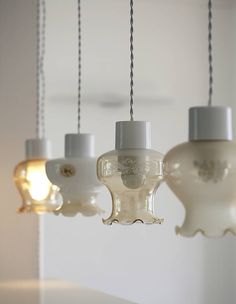 three light fixtures hanging from a ceiling in a room