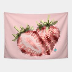 a cross - stitched strawberry with green leaves on it's pink wall hanging