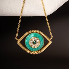 Inspired from the magical island of Crete, Greece this 18k yellow gold necklace, a turquoise enamelled eye pendant lined with natural white diamonds weight in total 0.035 cts., and a natural  tsavorite in the middle weighting 0.016 cts., tied on a 18 yellow gold long chain. Weight of 18k solid gold : 2.60 gr. (Adjustable) length of the chain necklace: 40.0 - 43.0 cm. / 15.75 - 16.93 inch.  Dimensions of the eye pendant: 16.0 * 11.5 mm. / 0.63 * 0.45 inch. Dynamic round shaped light blue enamelle Long Turquoise Necklace, Rose Gold Chain Necklace, Greece Summer, Solid Gold Charms, Gold Cross Necklace, Turtle Pendant, Summer Birthday, Elephant Pendant, Eye Pendant