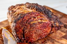 a large piece of meat sitting on top of a wooden cutting board