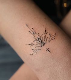 a woman's arm with a flower tattoo on it