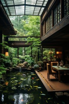 a room filled with lots of fish in a pond next to a table and chairs