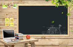 a desk with a laptop and books on it in front of a chalkboard wall