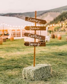 a hay bale filled with hay next to a wooden sign that says ceremony, dinner, cocktail and dance