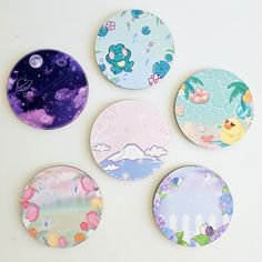 four coasters with different designs on them