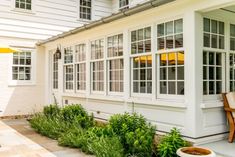 an outside view of a white house with lots of windows