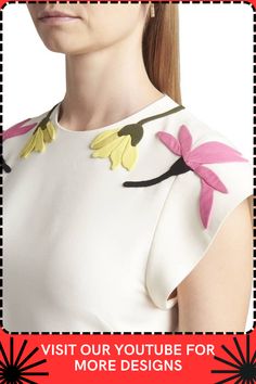 a woman in a white dress with flowers on her shoulder and the words visit our youtube for more designs