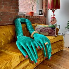 a couch that has some kind of monster hand on it