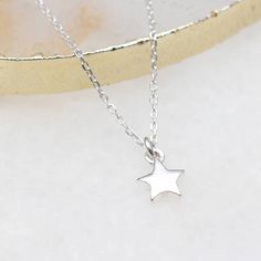 PRODUCT DESCRIPTION * This simple sterling silver tiny star necklace will make a perfect present for all age groups. * Hung from a sterling silver chain which is adjustable. * Matching earrings available. FREE GIFT BOX * This necklace comes beautifully packaged in a free Hurleyburley gift box. We can add a gift card for your special message. FREE STANDARD UK DELIVERY * Our standard postage is by Royal Mail 1st class post which has delivery guidelines of 1-2 working days but is not guaranteed to Tiny Star Necklace, Tiny Star, Mini Hoop Earrings, Vermeil Jewelry, Keep Jewelry, Star Pendant, Silk Ribbon, Silver Stars, Star Necklace