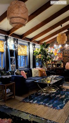 a living room filled with lots of furniture and windows covered in lights on top of them