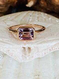 This classic east west bezel setting contains a beautiful 2.00ct natural Rose De France amethyst. The emerald cut stone measures approximately 8x6mm and the band is 2mm wide. The ring is available in sterling silver, and 14k white, yellow, or rose gold. This ring makes a unique promise or engagement ring. Please send me a message if you need a size not listed. * This ring can be customized with any color center stone. All items are handmade by me in my shop in Woodbridge, NJ. Please message me w Classic Amethyst Ring, Rose Gold Amethyst Ring With Birthstone, Rose Gold Amethyst Birthstone Ring, Classic Amethyst Rings With Bezel Setting, Rose Gold Amethyst Ring With Birthstone Detail, Lavender Emerald Cut Amethyst Ring, Elegant 14k Gold Amethyst Ring With Bezel Setting, Emerald Cut Lavender Gemstone Ring, Gold Emerald-cut Amethyst Ring