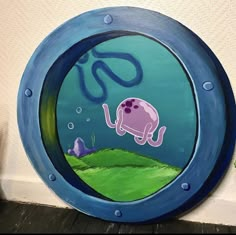 a painting of an elephant swimming in the ocean under a blue circular frame with letters on it