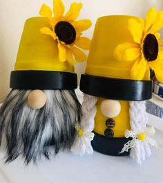 two yellow hats with flowers on them are sitting next to each other