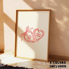 two hearts are drawn in red ink on a white paper next to a wooden frame