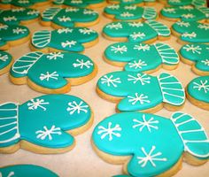 cookies decorated with blue and white icing on a table