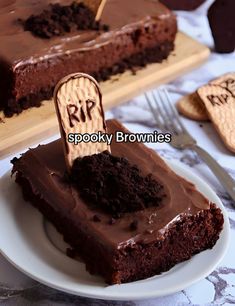 a piece of chocolate cake on a plate with the word rip spelled in wooden letters