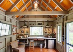 a kitchen with wood floors and wooden ceiling