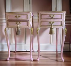 two pink nightstands with gold trim and tassels on the legs, one has a tasseled drawer