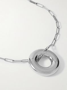 Laura Lombardi is renowned for its sculptural, contemporary jewelry that's designed with a focus on archival materials. This 'Terra' necklace is handmade from rhodium-plated recycled brass and comprised of slim, paperclip links strung with a sizable circular pendant. Modern Silver Chain Jewelry With Round Pendant, Modern Round Chain Necklace With Polished Finish, Timeless Metal Necklace With Polished Finish, Modernist Metal Necklace With Polished Finish, Modern Polished Metal Chain Necklace, Modern Link Necklace With Polished Finish, Modern Linked Necklace With Polished Finish, Metal Necklace With Round Pendant And Polished Finish, Contemporary Sterling Silver Necklace With Polished Finish