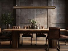 a dining room table with chairs and vases on top of it in front of a wall