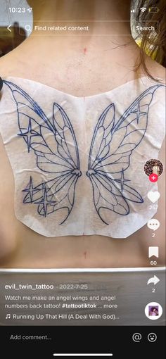 the back of a woman's bra with butterfly wings on it, and an arrow pointing