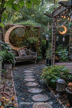 an outdoor garden with lots of plants and lights hanging from the ceiling, along with stepping stones