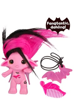 a pink troll doll with black hair and other accessories in front of a white background