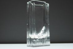 a clear vase sitting on top of a white table