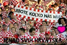 a group of people in red and white shirts holding signs