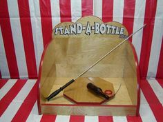 a wooden stand with a knife and some sort of tool on it's side