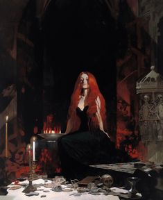 a woman with long red hair sitting in front of a table full of books and candles