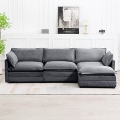 a living room with a gray couch and white rugs on the floor in front of a wall