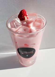 a drink with ice and a strawberry on the top is shown in front of a white background