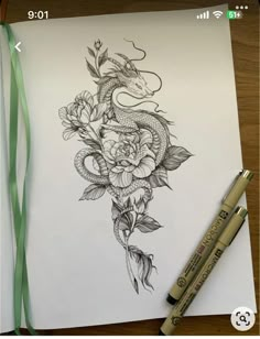 a drawing of a dragon and flowers on paper