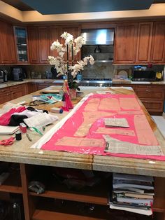 the kitchen counter is covered with construction paper and flowers in vases on top of it