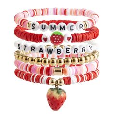 four different bracelets with charms and fruit charms on each one, including an apple