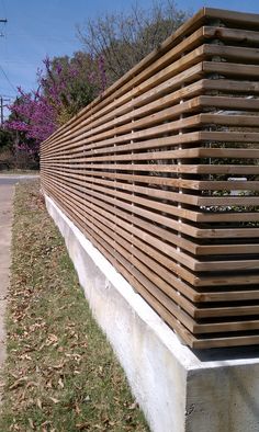 a wooden bench sitting on the side of a road