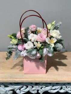 a pink box with flowers in it sitting on a table