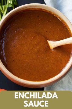 a bowl of enchilada sauce with a wooden spoon in it and the words enchilada sauce below