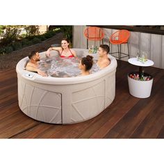 a group of people sitting in an outdoor hot tub