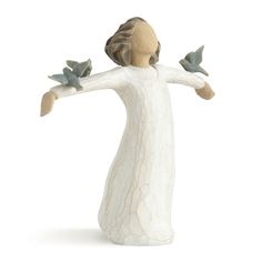 a figurine of a woman with two birds on her arm and arms outstretched