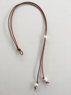 This black leather lariat and white freshwater pearl necklace adjust easily by placing two freshwater pearls through the loop closure to fasten. Casual yet elegant this necklace can accessorize any clothing style. Choose black, natural brown or copper brown leather in 16, 18, or 20 inch neck sizes. The three pearl drop measures and additional 2 1/2 - 3 inches. Slip the bottom two pearls through the loop for a lariat choker that adjusts to your preference. Slip your head through the leather and w Leather Beaded Necklace, Neutral Jewelry, Braided Leather Necklace, Pearl Lariat Necklace, Pearl Lariat, Copper Brown, Saint Augustine, Rustic Jewelry, Pearl Leather