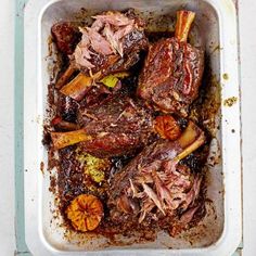 a tray filled with meat and vegetables on top of a table