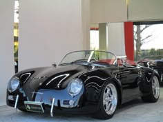 a black sports car parked in front of a building