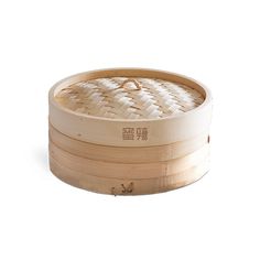 an empty bamboo steamer with lid on a white background