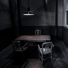 two chairs and a table in a dark room