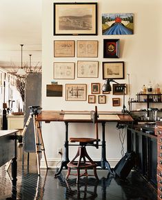 an old fashioned desk with lots of pictures on the wall